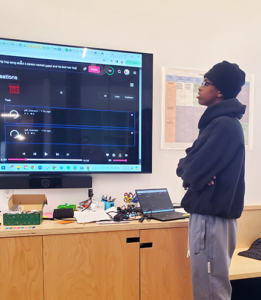 Student looks at code on large screen
