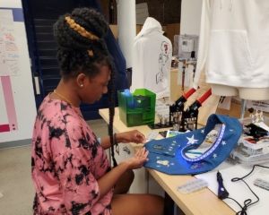 Student sews electronics into garment