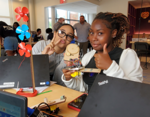 Two students thumbs up clean energy