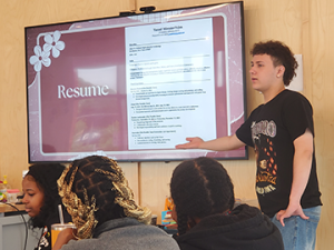 Student standing in front of a slide, presenting