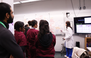 A clinician-educator instructs HS students on vital signs.
