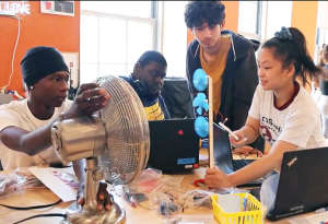 four students work on mini wind turbine project