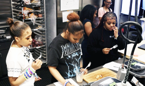 students taste testing and rating food on score cards