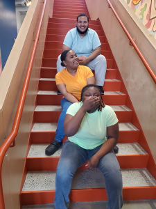 3 high school students laughing together