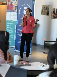 woman speaking in front of workshop attendees